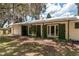 Charming home featuring a light-colored exterior with green shutters and a covered patio area at 23797 Ne 189Th St, Fort Mc Coy, FL 32134