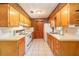 Functional kitchen with linoleum countertop, white appliances and tile flooring at 23797 Ne 189Th St, Fort Mc Coy, FL 32134