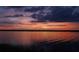 Stunning sunset reflecting over a tranquil lake with colorful, picturesque skies at 23797 Ne 189Th St, Fort Mc Coy, FL 32134