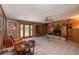 Cozy living room with a stone fireplace, tiled flooring, and natural wood accents at 23797 Ne 189Th St, Fort Mc Coy, FL 32134