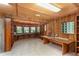 Unique wooden office space featuring wrap around desk, built-in shelving, and abundant natural light at 23797 Ne 189Th St, Fort Mc Coy, FL 32134