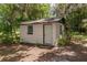 Exterior shot of a cozy storage shed with a clean, functional design and green trim at 23797 Ne 189Th St, Fort Mc Coy, FL 32134