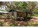 Exterior view of shed with attached carport and golf cart; ample outdoor storage at 23797 Ne 189Th St, Fort Mc Coy, FL 32134