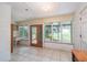 Bright sunroom featuring tile flooring, ample windows, and scenic outdoor views at 23797 Ne 189Th St, Fort Mc Coy, FL 32134