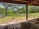 Expansive backyard view with mature trees, offering a serene and private outdoor space at 2580 Se 157Th Lane Rd, Summerfield, FL 34491
