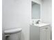 Clean bathroom with a vanity, mirror, and toilet, offering a simple and functional space at 2580 Se 157Th Lane Rd, Summerfield, FL 34491