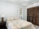 Bedroom with wood-look floors, natural light, and built-in closet at 2580 Se 157Th Lane Rd, Summerfield, FL 34491