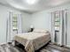 Bedroom with wood-look floors, natural light, and neutral colors at 2580 Se 157Th Lane Rd, Summerfield, FL 34491
