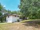 Stately ranch-style home with a two-car garage, featuring mature trees and a well-manicured lawn at 2580 Se 157Th Lane Rd, Summerfield, FL 34491