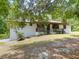 Charming single-story home with a well-maintained lawn and a inviting front porch, nestled under a shady tree at 2580 Se 157Th Lane Rd, Summerfield, FL 34491