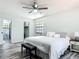 Main bedroom with ensuite bathroom, wood-look floors, and ceiling fan at 2580 Se 157Th Lane Rd, Summerfield, FL 34491