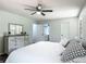 Main bedroom with ensuite bathroom, and dresser with decorative mirror at 2580 Se 157Th Lane Rd, Summerfield, FL 34491