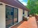 Covered porch with neutral-toned furniture, perfect for enjoying the outdoors in comfort and style at 2580 Se 157Th Lane Rd, Summerfield, FL 34491