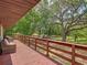 Expansive porch with wood flooring, offering ample space for outdoor relaxation and entertaining at 2580 Se 157Th Lane Rd, Summerfield, FL 34491