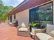 Relaxing outdoor patio with comfortable seating, ideal for enjoying the lush natural surroundings at 2580 Se 157Th Lane Rd, Summerfield, FL 34491