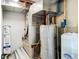Mechanical room containing the HVAC system and water heater, essential for home comfort and efficiency at 2580 Se 157Th Lane Rd, Summerfield, FL 34491