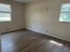 Empty bedroom featuring laminate floors, light-colored walls, and two windows for ample lighting at 312 Nw 28Th St, Ocala, FL 34475