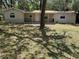 Charming single-story home featuring a covered front porch and stone accents, nestled among mature trees at 312 Nw 28Th St, Ocala, FL 34475