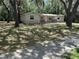 Charming single-story home featuring a covered front porch, nestled among mature trees and green space at 312 Nw 28Th St, Ocala, FL 34475