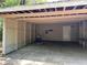 Garage featuring concrete flooring, a utility sink, and a side entrance door at 312 Nw 28Th St, Ocala, FL 34475