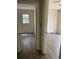 Hallway view leading to bedrooms, highlighting flooring and natural light from a nearby window at 312 Nw 28Th St, Ocala, FL 34475