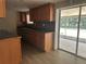 Kitchen featuring wood cabinets, a sink, and sliding glass doors to the outdoors at 312 Nw 28Th St, Ocala, FL 34475