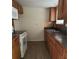 Kitchen featuring wooden cabinets, a stainless steel sink, and white appliances at 312 Nw 28Th St, Ocala, FL 34475