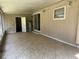 Covered patio with tiled flooring leading to a door and the water heater at 312 Nw 28Th St, Ocala, FL 34475
