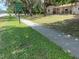 Street view of property featuring mature trees, grassy lawn and Powerhouse Ministry sign at 312 Nw 28Th St, Ocala, FL 34475