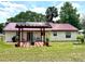 Spacious backyard featuring a pergola, solar panels, and a metal roof with well-maintained grass at 340 Oak Track Loop, Ocala, FL 34472