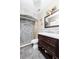 Updated bathroom featuring a modern vanity, double sinks, and a tiled walk-in shower at 340 Oak Track Loop, Ocala, FL 34472