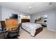 Cozy bedroom with a full-size bed, wooden dresser, and a mirrored closet door at 340 Oak Track Loop, Ocala, FL 34472