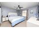Comfortable bedroom with queen bed, ceiling fan, and matching nightstands with a large window at 340 Oak Track Loop, Ocala, FL 34472