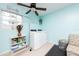 Charming laundry area with a window for natural light, modern washer and dryer, and a decorative ceiling fan at 340 Oak Track Loop, Ocala, FL 34472