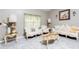 Inviting living room with light gray floors, large windows, and classic furniture at 340 Oak Track Loop, Ocala, FL 34472