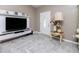 Cozy living room featuring light gray floors in a chevron pattern and ample natural light at 340 Oak Track Loop, Ocala, FL 34472