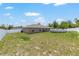 This expansive backyard includes a pool, lush green grass, and a secure white fence, providing a serene outdoor space at 3887 Sw 156Th Pl, Ocala, FL 34473