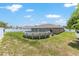 Spacious backyard featuring a round pool, well-maintained lawn, and a fenced perimeter at 3887 Sw 156Th Pl, Ocala, FL 34473