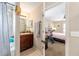 Bathroom sink and vanity with a view of the bedroom through an open doorway at 3887 Sw 156Th Pl, Ocala, FL 34473