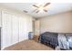 Bedroom with carpet flooring, a ceiling fan, a closet, and natural light at 3887 Sw 156Th Pl, Ocala, FL 34473