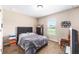 Bedroom featuring carpet flooring, a bed, and natural light from a window at 3887 Sw 156Th Pl, Ocala, FL 34473