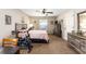 Bedroom with neutral walls, a ceiling fan, carpet, and a bed with light pink bedding at 3887 Sw 156Th Pl, Ocala, FL 34473