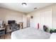 A functional bedroom featuring a comfortable bed, a study desk, and ample closet space at 3887 Sw 156Th Pl, Ocala, FL 34473