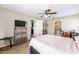 Bedroom with neutral walls, carpet, ceiling fan, and doorway views into the kitchen and bathroom at 3887 Sw 156Th Pl, Ocala, FL 34473