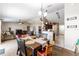 Open-concept dining area with modern lighting, seamlessly connected to living and kitchen at 3887 Sw 156Th Pl, Ocala, FL 34473