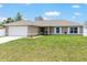 Charming single story home with a well-manicured lawn and inviting front entrance at 3887 Sw 156Th Pl, Ocala, FL 34473