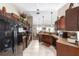 Well-equipped kitchen with tile flooring, modern appliances, and dark wood cabinetry at 3887 Sw 156Th Pl, Ocala, FL 34473