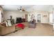 Comfortable living room with plush carpeting, ceiling fan, and neutral color palette at 3887 Sw 156Th Pl, Ocala, FL 34473