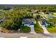 An aerial view of a neatly landscaped property with a spacious backyard surrounded by lush greenery and neighboring homes at 3897 Sw 169Th Lane Rd, Ocala, FL 34473