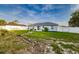 An expansive backyard showcasing a well-kept lawn, complemented by tasteful landscaping and complete privacy fence at 3897 Sw 169Th Lane Rd, Ocala, FL 34473